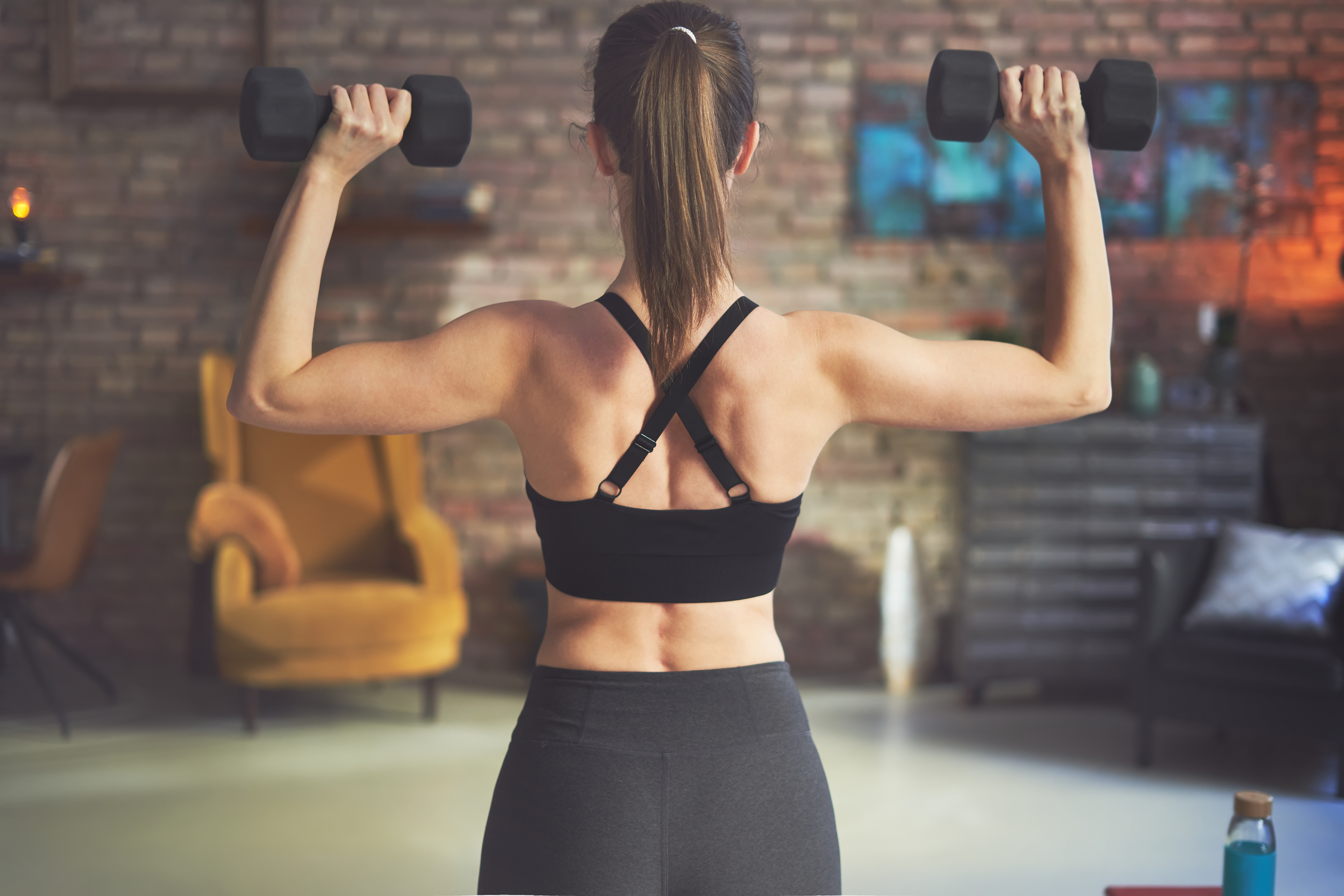 Woman Training, Doing Exercise and Weight Training at Home 